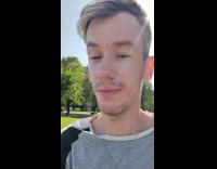 Man selfie green cap tiktok dance park