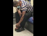 Passenger picks at his feat on seat 