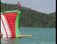 Guy backflip red green inflatable obstacle course