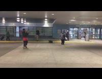a man plays trumpet in front of penn station