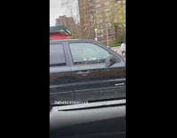 Guy Parked Plays Flute in Black Car 