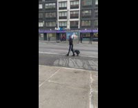 Man talks use his megaphone along street 