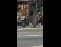 Man Monologues Alone on Sidewalk Across Street