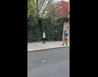 Woman white sweater street assistant use air blower