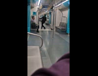 Man in suit dances inside the train