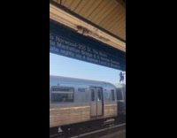 Guy subway surfing on moving D train