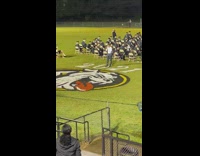 Guy waves shirt and yells in support of singer 