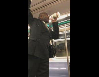 Man yells on subway train uses a bottle of cranberry juice as a microphone