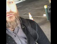 Guy flips an orange traffic cone behind him and stacks it perfectly on top