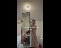 Girl holding up mirror in pink robe