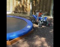 Two little boys back up toy car