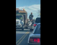 Woman with helmet on tall unicycle