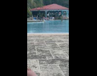 Girl sits on edge of pool