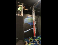 Man jumps into foam pit while waiting for his turn on high bar