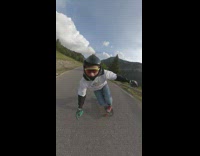 Guy riding long board down mountain road falls 