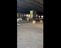 Collab WINY - Man in white safety attire rides OneWheel