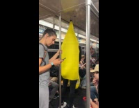Man banana costume tells joke inside train