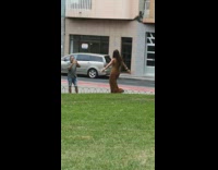Woman brown long dress dance video shoot public park