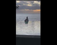 Woman bikini sit poolside imitate pose sunset