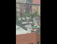 Guy on rooftop punches rug on canopy frame 