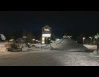 Giant snowman street night small town excavator