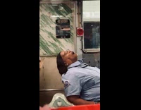 MTA subway worker fallen asleep on the chair in the information booth 
