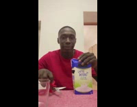 Guy puts lid spout on milk container 