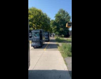 Modern delivery vehicles on side of street