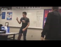 Guy points stapler at black shirt friend 