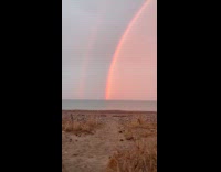 Woman sees double rainbow out in the ocean