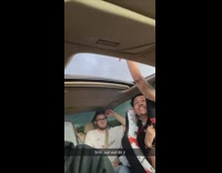 Friends light firework in car 
