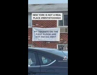 Sign on the side of a building exposing tenants