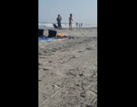 Woman pink bikini tiktok dance video shoot beach