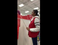 Michaels worker dusts the air with purple duster at the end of her shift