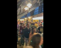 Woman films the line for the restrooms