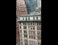 Man cleans building with no safety gear