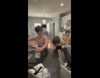 Boys take turns filling up glass cup with water challenge