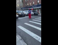 Guy in clown costume juggling for stopped cars