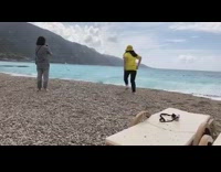 Woman yellow shirt hat run pose beach