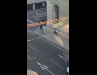 Denim jacket girl poses sidewalk guy scooter 