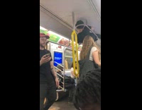 Guy hanging on ceiling roof of subway train 