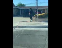 Guy standing outside pees on sidewalk 