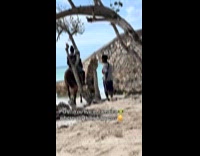 Man riding horse at beach goes through hole in wall