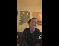 Woman black shirt and her white dog sings along to music