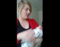 Mom holds newborn baby 