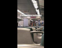 Subway passenger sticks legs straight up on seats seen across train 