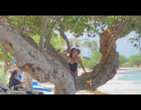 Girl black hat sit between tree  trunk