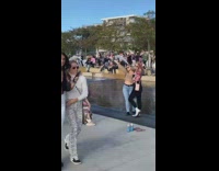 Two women park water fountain pose
