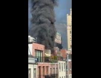 Submitter shows apartment building rooftop on fire 