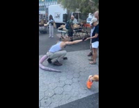 Guy wearing rat mask crawls around farmers market 
